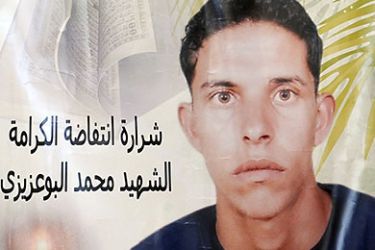 A photo taken on November 15, 2011 shows a poster featuring Mohamed Bouazizi, the fruitseller whose self-immolation sparked the revolution that ousted a dictator in Yunisia and ignited the Arab Spring.