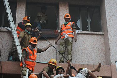 INDIA : Rescue workers evacuate people after a fire engulfed a hospital in the eastern Indian city of Kolkata on December 9, 2011.