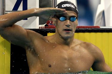 Oussama Mellouli of Tunisia salute after winning gold medal of the men's 100m butterfly at the 2011 Arab Games in the Qatari capital Doha on December 18, 2011. AFP PHOTO/