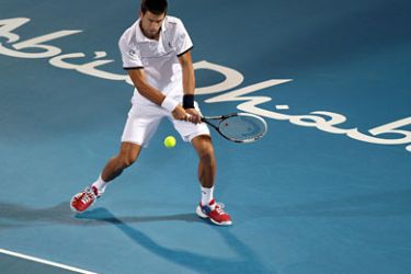 ف-World number one Novak Djokovic of Serbia returns to Gael Monfils of France during their Mubadala World Tennis