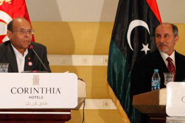 Libyan National Transitional Council (NTC) leader Mustafa Abdel Jalil (R) listens as Tunisia's President Moncef Marzouki speaks at a joint news conference in Tripoli January 2, 2012.