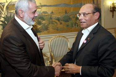 Tunisian President Moncef Marzouki (R) greets Gaza's Hamas prime minister Ismail Haniya (L) on January 5, 2012 in Carthage Palace inTunis. Haniya is on two-day official visit to Tunisia.