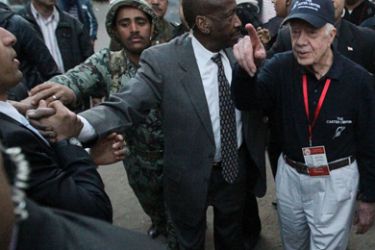 Former US president Jimmy Carter waves upon his arrival to a polling station in Cairo's Al-Sahel district during the January 10, 2012 round of a three-staged election launched in November to choose the first parliament since mass protests forced former president Hosni Mubarak to quit.
