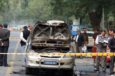 Investigators take a closer look at a vehicle that exploded near the Israeli embassy in New Delhi on February 13, 2012.