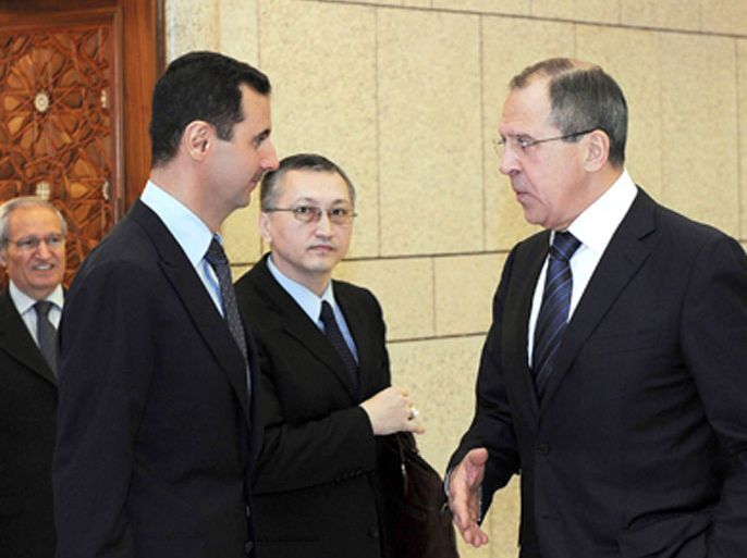 Syria's President Bashar al-Assad (L) talks to Russia's Foreign Minister Sergei Lavrov (R) in Damascus February 7, 2012, in this handout photograph released by Syria's national news agency SANA. Lavrov began talks with Assad on Tuesday by saying Moscow wants Arab peoples to live in peace and the Syrian leader is aware of his responsibility, Russian news agency RIA reported.