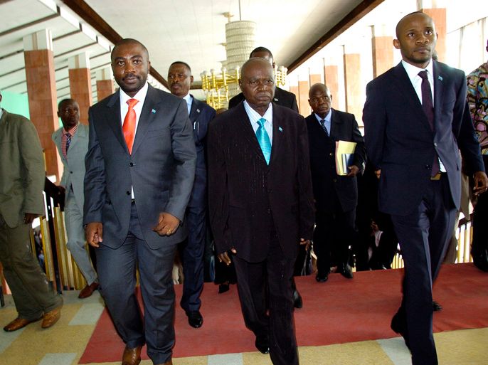 Congo : Timonthe Kombo Nkisi (C), flanked by first secretary Patrick Muyaya (L) and second secretary Dialo Mukula leave after the extraordinary session of the National Assembly in Kinshasa on February 16, 2012. The session was scheduled to set up a temporary bureau with Timonthe Kombo Nkisi, from the UDPS (Union for Democracy and Social Progress) as its president.