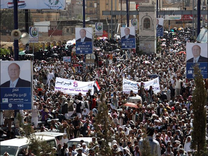 afp : Yemeni demonstrators gather under campaign posters of vice president and sole presidential candidate Abdrabuh Mansur Hadi during a rally in support of next week's presidential election in Sanaa on February 17, 2012. Referendum-like elections will be held in Yemen on February 21 to approve Hadi as a consensus president for a two-year term to replace President Ali Abdullah Saleh, who is stepping down after a year of protests under a Gulf-brokered deal. AFP PHOTO/ MOHAMMED HUWAIS