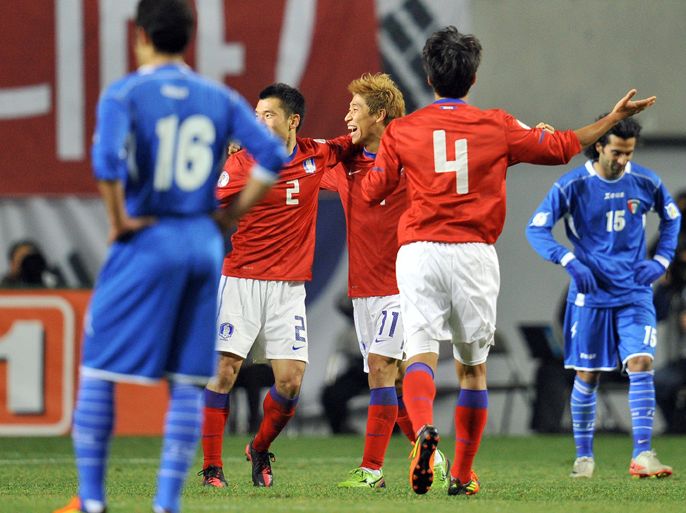 South Korea's Lee Keun-Ho (C #11) celebrates his goal with teammates during their World Cup Asian Qualifiers round three football match against Kuwait in Seoul on February 29, 2012. South Korea won the match 2-0. AFP PHOTO/JUNG YEON-JE
