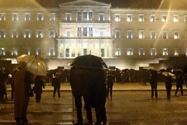 Participants of a demonstration against the upcoming austerity economic measures hold umbrellas during a heavy rainfall in Athens on February 6, 2012. The EU warned today that Greek politicians are living on borrowed time if they are to deliver on past promises, agree new commitments and slash the country's debts in exchange for a new bailout. AFP