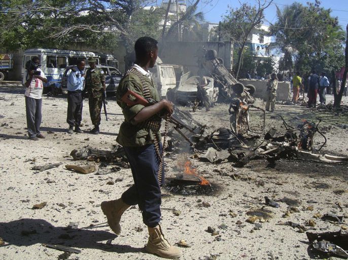 A government policeman walks at the scene of an explosion in Hodan district of Somalia's capital Mogadishu, February 17, 2012