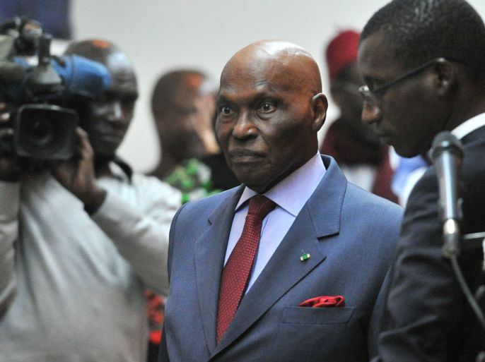 egalese President Abdoulaye Wade (C) arrives on February 27, 2012 for a public declaration at the presidential palace in Dakar.