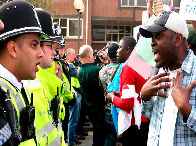 epa00982011 A demonstrator stresses his point to a policeman as hundreds of activists gather to protest against Democratic Republic of Congo's President Joseph Kabila and Britain's Immigration policies outside Sandford House, Solihull, West Midlands on Thursday, 12 April, 2007