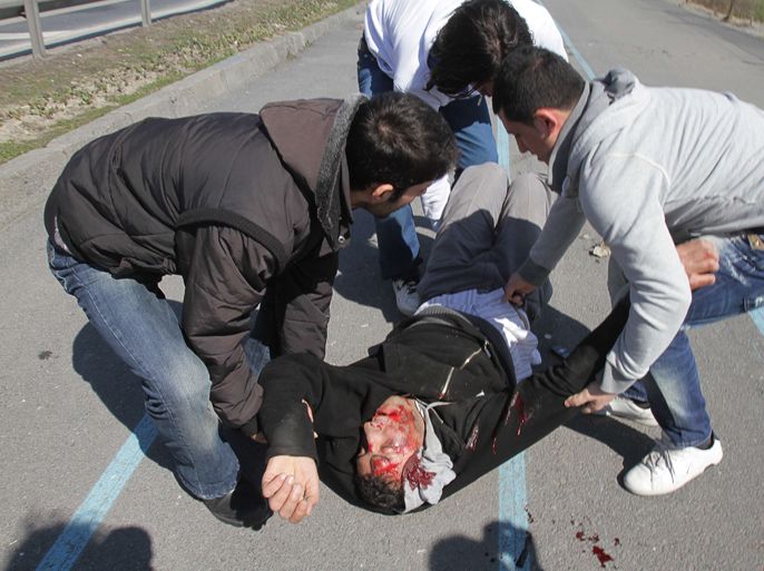 Kurdish protesters help an injured demonstrator after clash with Turkish police during a Noruz celebration in Istanbul on March 18, 2012. Thousands of Kurds clashed with police in Istanbul and the southern city of Diyarbakir after police used water cannon and tear gas to try and stop Kurdish New Year festivities.
