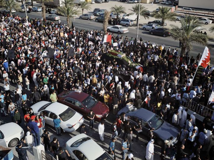 Bahrainis take part in the funeral procession of Saida Fadhel Mirza al-Obeidi, on March 10, 2012, in Diraz, a village east of Manama. Obeidi sustained a police gunshot wound to the head on March 1 in Diraz, the Gulf state's main Shiite opposition group Wefaq said. AFP PHOTO/STR