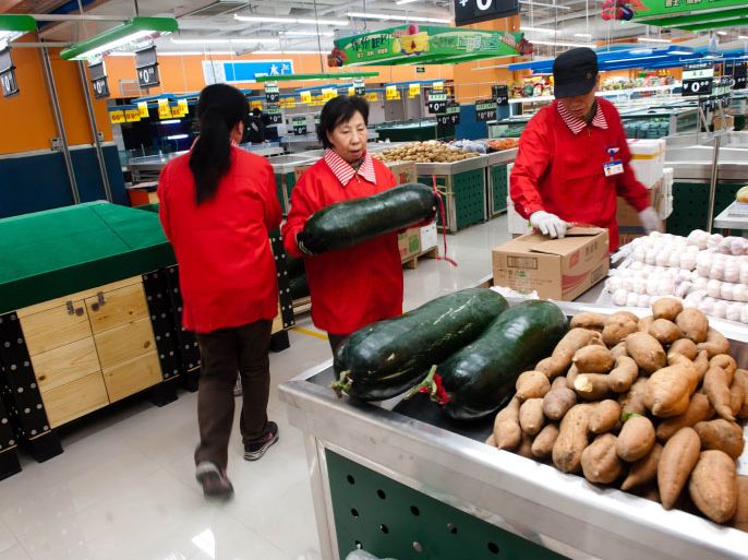 In this photograph taken on March 8, 2012, Chinese workers sort food at a supermarket before opening in Beijing. China's inflation rate slowed sharply in February from the previous month, official data showed, giving Beijing more room to loosen credit restrictions to boost flagging economic growth. CHINA OUT AFP PHOTO