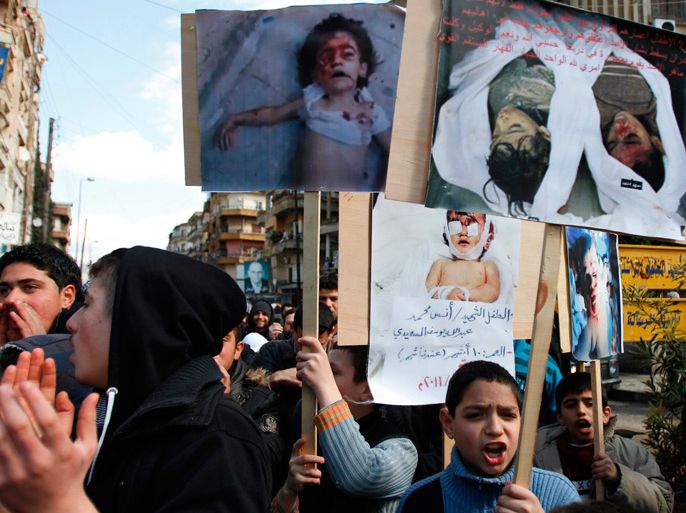 Lebanese and Syrians living in Lebanon, carry pictures of children who they say were killed by Syrian security forces, during a protest against Syria's President Bashar al-Assad and to express solidarity with Syria's anti-government protesters in Tripoli in northern Lebanon March 2, 2012.