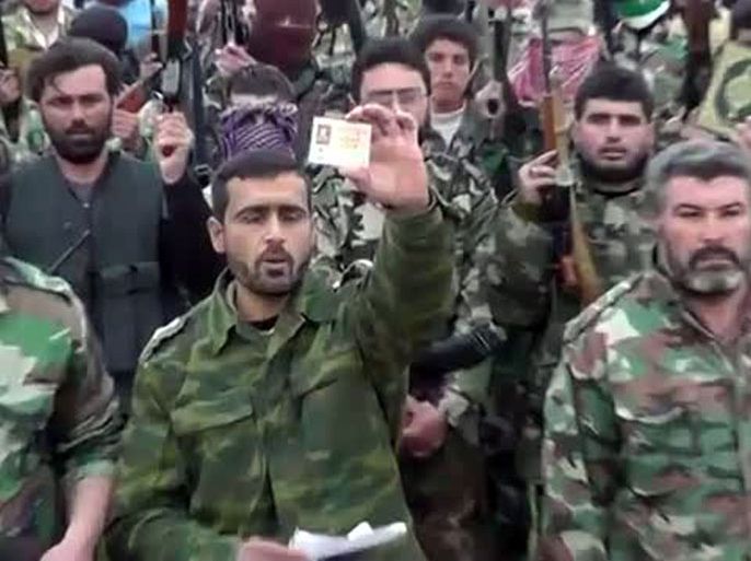 An image grab taken from a video uploaded on YouTube on February 28, 2012, shows a Syrian army dissident, Captain Hashem al-Hassan showing his ID card as announces the newly formed Sheikh Hamad Bin Jassim Brigade