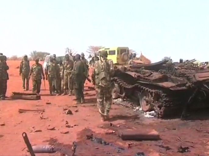 An image grab taken from footage obtained by AFP shows Sudanese troops standing next to a destroyed tank on March 29, 2012, one day after recapturing Sudan's southern oil centre of Heglig following fighting with South Sudanese forces along the border. Southern troops had taken the Heglig oil field, parts of which are claimed by both countries, but Sudanese forces later retook the field as both sides vowed to step back from the brink of all out war after three days of border violence including airstrikes and tank battles.