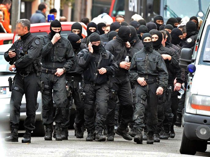 French members of the RAID special police forces unit leave after the assault on the besieged flat of self-professed Al-Qaeda militant Mohamed Merah, on March 22, 2012 in Toulouse, southwestern France. Mohamed Merah died in the assault and "jumped from the window still shooting," Interior Minister Claude