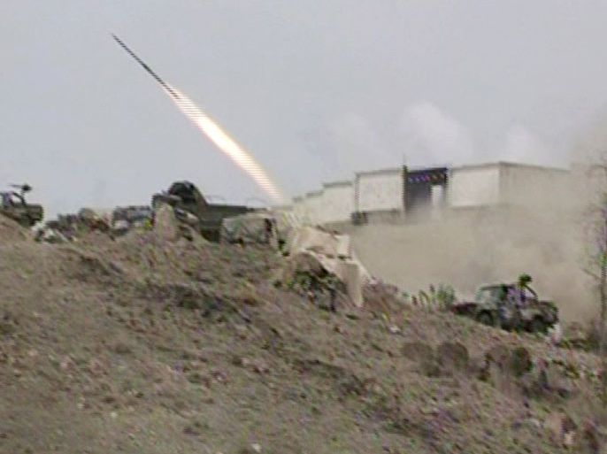 An image taken with a mobile phone shows a Yemeni army vehicle firing a rocket during fighting between army forces and militant supporters of the al-Qaeda in the south Yemen town of Loder, in Abiyan province, on April 14, 2012. At least 222 people including 183
