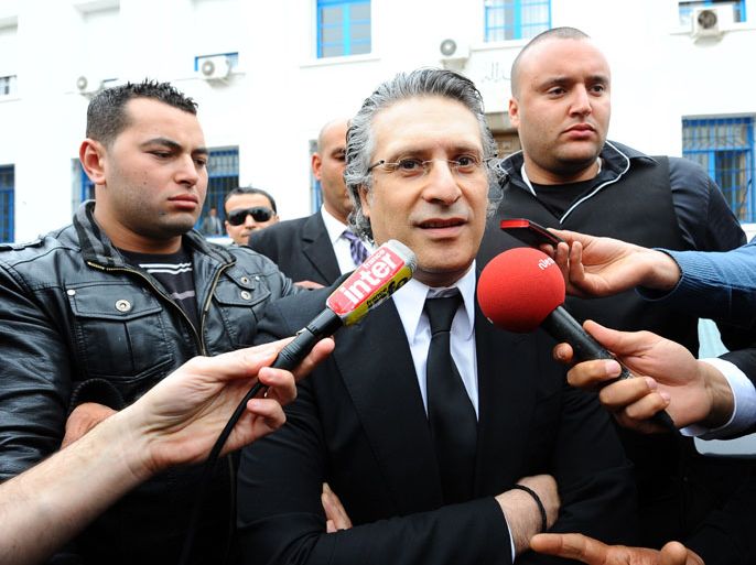 The director of the Tunisian private TV channel Nessma television, Nabil Karoui (C), leaves the courthouse on April 19, 2012 in Tunis after the postponment of his trial. Karoui is charged with "insulting sacred values" for broadcasting the Iranian film "Persepolis" in October 2011.