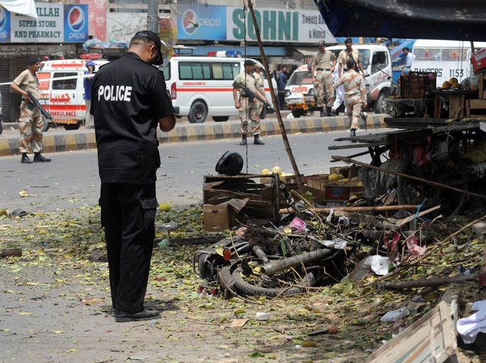 Pakistani paramilitary soldiers cordon-off the site of a suicide bomb attack in Karachi on April 5, 2012. A suicide bomber targeted a police official in Pakistan's financial capital Karachi on April 5, killing at least three people and wounding 13 others, police said. AFP PHOTO/Asif HASSAN