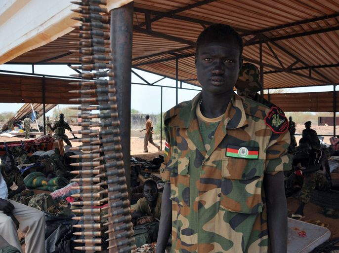 A soldier stands around at aSudanese Peoples Liberation Army (SPLA) base near the frontline where soldiers wait for any attack from Sudanese goverment, on April 23, 2012 a base in Bentiu. Sudanese war planes launched a fresh bombing raid on a key South Sudanese town Monday, dashing hopes that a withdrawal of Southern troops from a contested area would end weeks of fighting. Several bombs were dropped on Bentiu, capital of the oil-rich South Sudan border state of Unity, killing at least one child and wounding several civilians, an AFP reporter witnessed. AFP