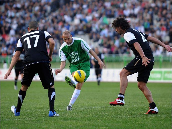 Former Italian football player Alessandro Altobell (C) kicks the ball during a gala football match for African children at the July 5th stadium in Algiers on April 23, 2012. AFP PHOTO/ FAROUK BATICHE