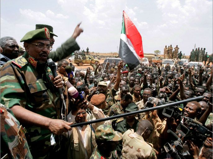 Sudanese President Omar al-Bashir (L) addresses celebrating troops in Sudan's main petroleum centre of Heglig on April 23, 2012 where Sudan's army says more than 1,000 Southern soldiers died in battle. Bashir said there will be no more talks with South Sudan, as fresh Sudanese air raids dashed hopes for an end to weeks of fighting. AFP PHOTO/ASHRAF SHAZLY