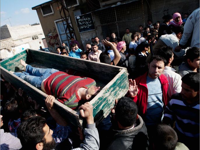 Neighbors and relatives carry the coffin of Abdel Salam Khazal, 20, of the rebel Free Syria Army (FSA) during his funeral in Anadan, north Syria, on April 21, 2012. Khazal was allegedly killed in an ambush near a checkpoint on the outskirts of Babis, north of Aleppo, in which nine people were killed according to the Syrian Observatory for Human Rights.