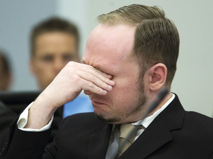 Rightwing extremist Anders Behring Breivik, who killed 77 people in twin attacks in Norway last year, shares a tear as court views propaganda film he made, during his trial in Oslo courthouse on April 16, 2012. Breivik told the Court that he did not recognise its legitimacy. Since Breivik has already confessed to the deadliest attacks in post-war Norway, the main line of questioning will revolve around whether he is criminally sane and accountable for his actions, which will determine if he is to be sentenced to prison or a closed psychiatric ward. AFP PHOTO / POOL / Heiko Junge