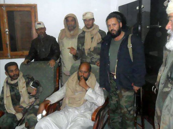 epa03055726 (FILE) A file handout photograph made available on 21 November 2011 from the Libyan Youth Movement Facebook page, shows Saif al-Islam (Bottom-C), the son of slain Libyan leader Muammar Gaddafi, surrounded by unidentified members of the Abou Bakr Essedik revolutionaries unit upon his arrest in southern Libya and his transfer to Zintan, Libya early 19 November 2011. According to media reports on 09 January 2012 the International Criminal Court (ICC) has extended a deadline for Libya to provide information on the health and status of Saif al-Islam Gaddafi. The deadline is now 23 January 2012. The ICC, based in in The Hague, has indicted him for crimes against humanity. EPA/LIBYAN YOUTH MOVEMENT FACEBOOK BEST QUALITY AVAILABLE HANDOUT EDITORIAL USE ONLY/NO SALES *** Local Caption *** 00000403010583