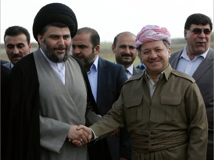 Iraqi Shiite cleric Moqtada al-Sadr (L) shakes hands with Iraqi Kurdish leader Massud Barzani upon Sadr's arrival at Arbil airport for a visit to Iraq's autonomous Kurdistan region in what his spokesman said was a bid to resolve a crisis between the region and Baghdad on April 26, 2012. AFP PHOTO/SAFIN HAMED