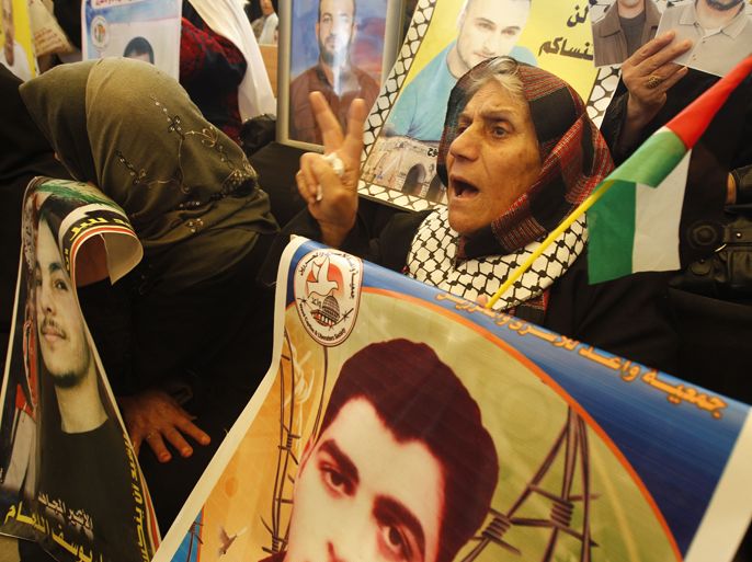 Palestinian women hold up portraits of incarcerated relatives during a protest calling for the release of Palestinian prisoners held in Israeli jails outside the Red Cross offices in Gaza City on April 23, 2012. At least 1,350 Palestinian prisoners being held in Israel are observing an open-ended hunger strike, the Israeli Prisons Service said on April 22, after another 150 inmates began refusing food to protest the conditions in which they are being held. AFP