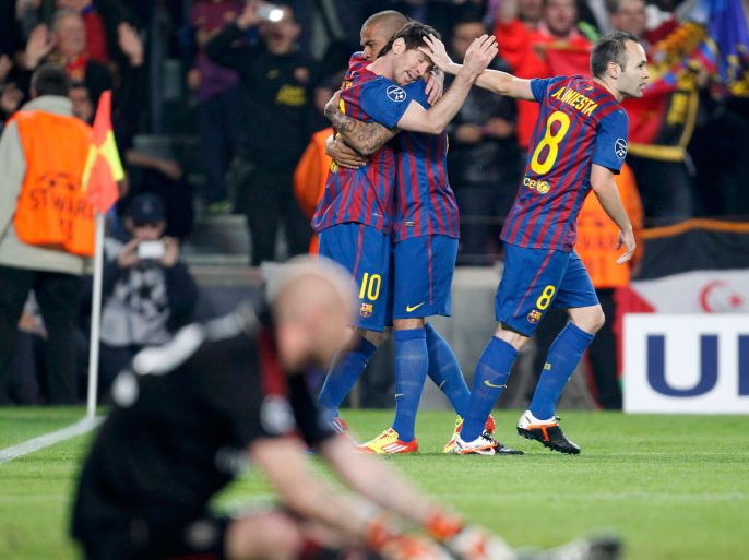 Barcelona's Lionel Messi (rear L) celebrates with Daniel Alves (rear C) and Andres Iniesta (rear R) after scoring a penalty past AC Milan goalkeeper Christian Abbiati (front) during their Champions League quarter-final second leg soccer match at Camp Nou stadium in Barcelona April 3, 2012. REUTERS/Giampiero Sposito (SPAIN - Tags: SPORT SOCCER)