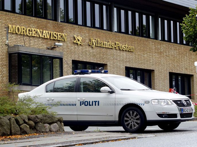 (FILES) Picturea taken on September 12, 2010 shows a police car guarding the entrance of Danish newspaper Jyllands-Posten in Viby, Jutland. Four men pled not guilty on April 13, 2012 as they went on trial in Denmark over a suspected plot to massacre the staff of a newspaper that first published controversial cartoons of the Prophet Mohammed. AFP PHOTO/SCANPIX DANMARK/Brian Rasmussen