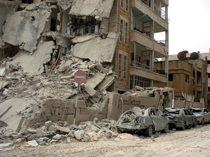 A handout picture released by the official Syrian Arab News Agency (SANA) shows a building and vehicles that were damaged following blasts in the city of Idlib, northwest Syria, on April 30, 2012. More than 20 people were killed in the blasts targeting security buildings in Idlib, the Syrian Observatory for Human Rights said, as the Syrian state television put the death toll at eight, among them civilians. AFP