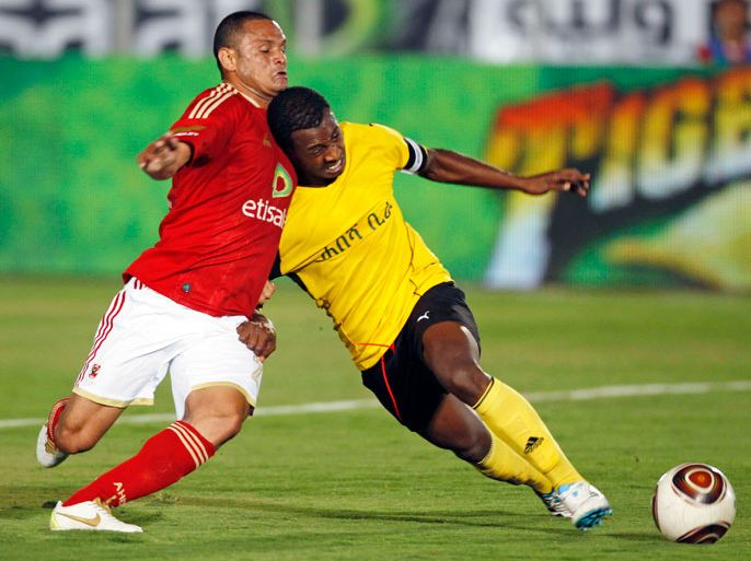 Fabio Junior of Egypt's Al Ahly (L) fights for the ball with Danial Gabry of Ethiopian Coffee FC during their CAF Champions League soccer match at the Military Stadium in Cairo April 8, 2012. The match is the first official game for Al Ahly in Egypt since February 1, when 74 spectators died in a clash after their match in Port Said Stadium. REUTERS/Amr Abdallah Dalsh (EGYPT - Tags: SPORT SOCCER)