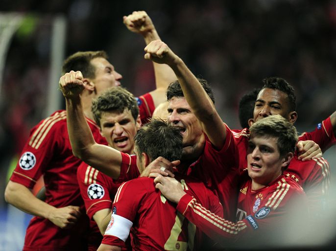 Bayern Munich's striker Mario Gomez (C) celebrates with teammates after scoring the 2-1 during the UEFA Champions League first-leg semi-final football match Bayern Muenchen vs Real Madrid in Munich, southern Germany, on April 17, 2012. Bayern Munich won the match 2-1. AFP