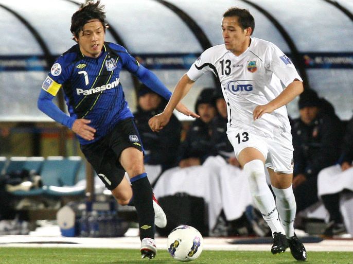 Japan's Gamba Osaka midfielder Yasuhito Endo (L) and Uzbekistan's Bunyodkor midfielder Lutfulla Turaev (L) chase the ball during the second half of the Asia Champions League in Osaka on April 3, 2012. Gamba defeated Bunyodkor 3-1. AFP PHOTO / JIJI PRESS JAPAN OUT