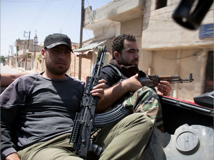 Syrian rebels patrol in Qusayr,15 kms (nine miles) from Homs, on May 6, 2012. Syria's authorities and the opposition traded accusations over who was behind blasts that rocked Damascus and Aleppo, on the eve of parliamentary polls designed to boost the regime's legitimacy. AFP PHOTO/STR