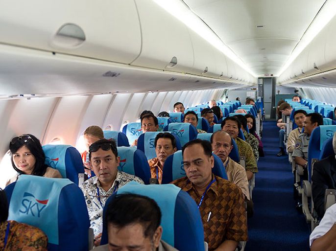 KAD183 - in flight, -, INDONESIA : A handout photo provided by Sergey Dolya shows indonesian passengers during the first demonstartion flight of Sukhoi Superjet 100 in Indonesia, on May 8, 2012. The plane on a demonstration flight with at least 44 people aboard went missing in a mountainous area south of the Indonesian capital Jakarta, officials said.