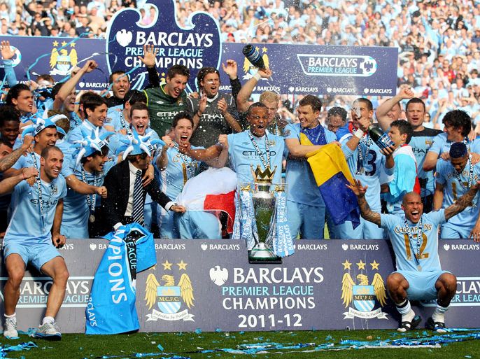 MANCHESTER, ENGLAND - MAY 13: The Manchester City players celebrate with the trophy following the Barclays Premier League match between Manchester City and Queens Park Rangers at the Etihad Stadium on May 13, 2012 in Manchester, England. (Photo by Alex Livesey/Getty Images)
