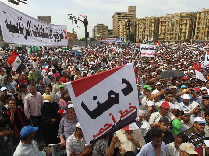 Egyptians protest against the military rule in Cairo's Tahrir square on May 4, 2012 with the slogan (foreground): "Our blood is a red line", as thousands of people took to the streets in the Egyptian capital and the Mediterranean port city of Alexandria, days after bloody clashes near the defence ministry raised tensions ahead of landmark presidential elections. AFP
