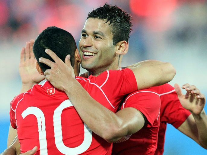 Tunisia's Hamdi Harbaoui celebrates with his teammates after scoring against Rwanda during their friendly football match at Ben Jannet Olympic stadium in Monastir on May 27, 2012. AFP PHOTO / FETHI BELAID