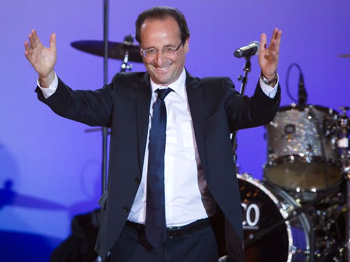 French Socialist Party (PS) presidential candidate Francois Hollande celebrates on stage after winning the second round of the French presidential elections, on Place de la Bastille, in Paris, France, 06 May 2012. French Socialist candidate Francois Hollande defeated incumbent Nicolas Sarkozy in the final round of France's presidential election, with exit polls indicating that Hollande is leading with approximately 52 per cent of the vote. EPA/IAN LANGSDON