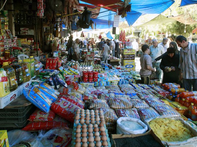 59 Syrians are seen bying food at Sheik Mohi El-Deen market in the