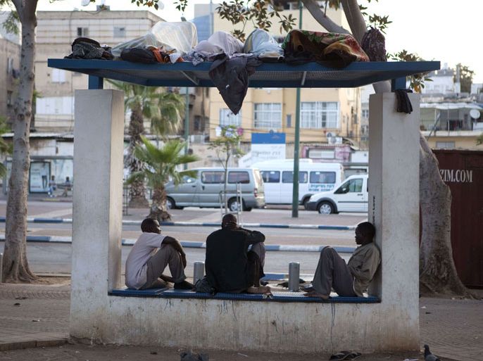 ISRAEL : African migrants sit in a bus stop at Levinsky Park in southern Tel Aviv, early morning on May 25, 2012. Violent race riots that shook southern Tel Aviv two nights ago sparked shock in Israel, but also prompted top-level calls for the immediate arrest and expulsion of tens of thousands of African migrants. AFP PHOTO/MENAHEM KAHANA