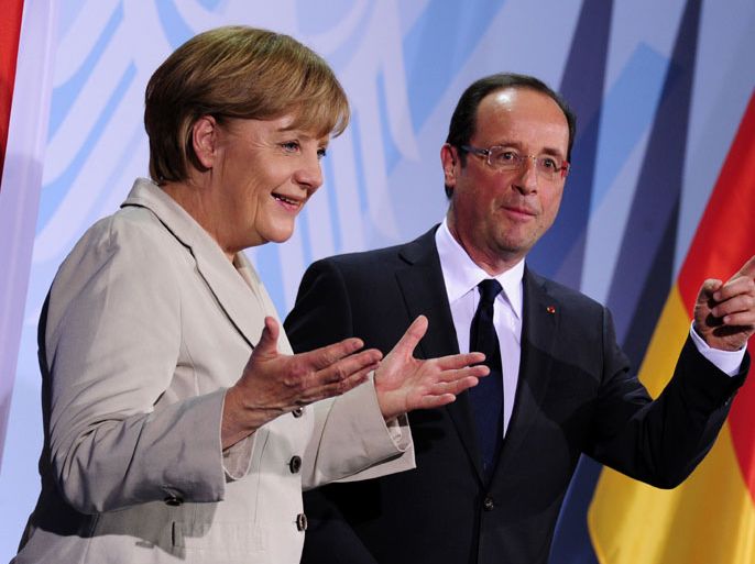 German Chancellor Angela Merkel (L) and the new French president Francois Hollande gesture after addressing a press conference at the German Chancellery on May 15, 2012 in Berlin.