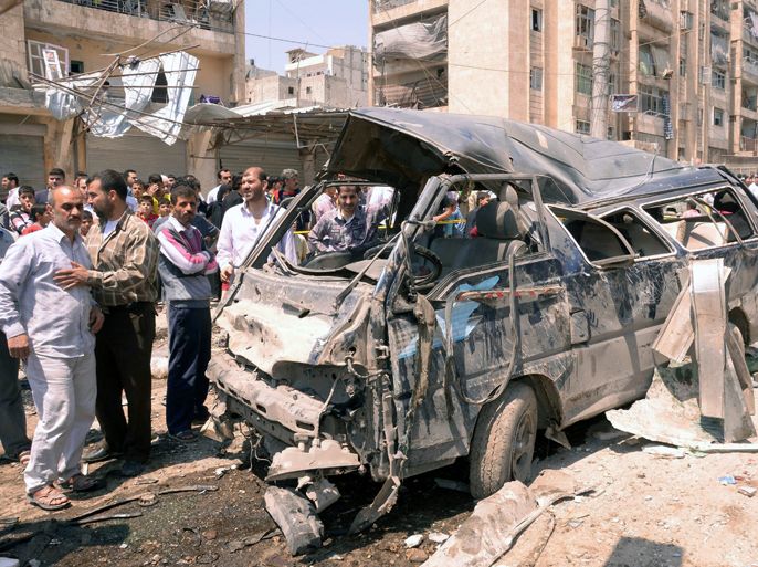 epa03206966 A handout photo made available by Syrian Arab News Agency (SANA), shows the wreck of a car at the explosion site in al-Sukkari neighborhood in the northern province of Aleppo, Syria. According to SANA, three citizens, including a child, were killed and 21 other were injured in a booby-trapped car blast that went off on 05 May 2012 in front of a car wash. EPA
